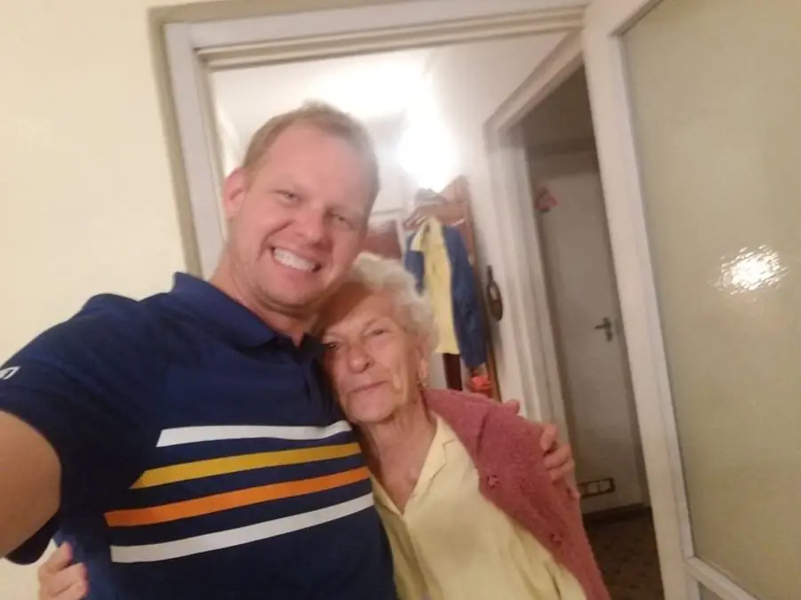 Grandma and me in a hug, taking a selfie in her hallway