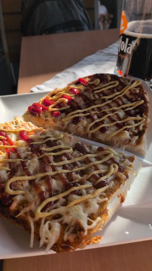 A hot open sandwich with melted cheese, ketchup and mustard, and a Kofola, at Komp Café in Štúrovo