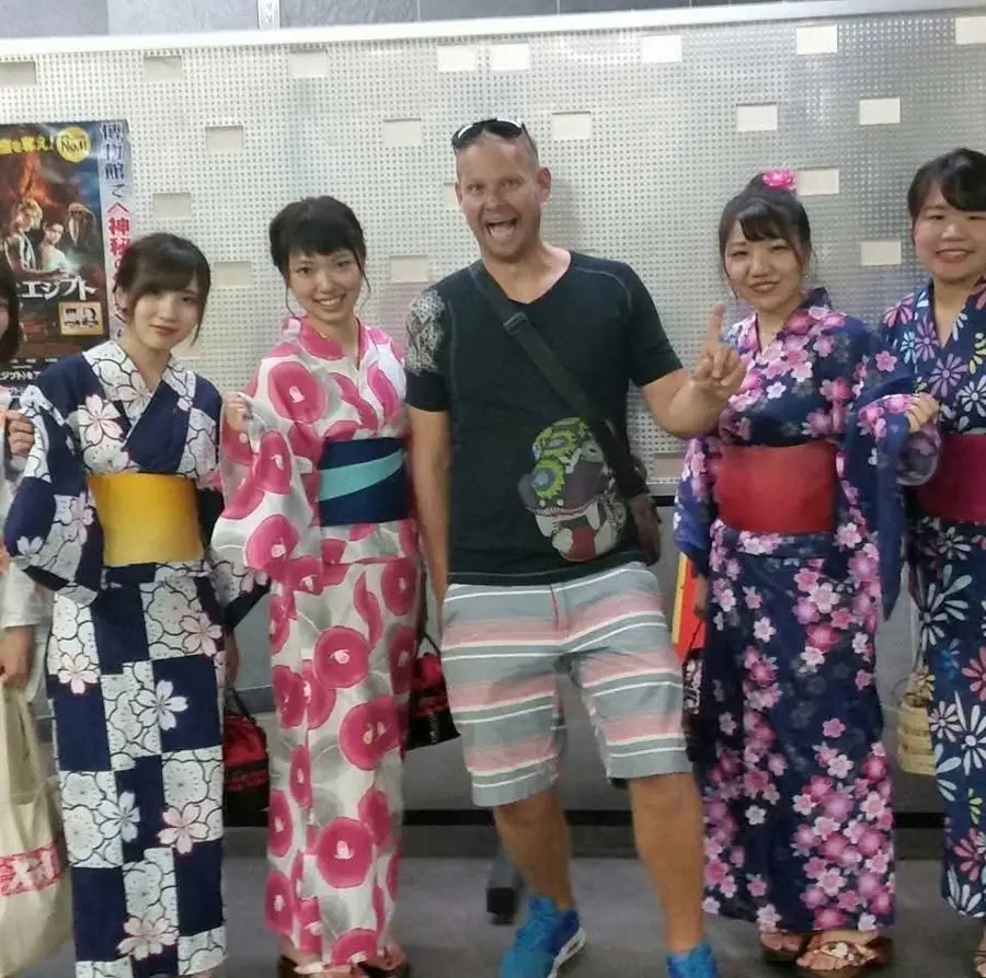Me grinning in the middle of a group of young women in colorful summer kimonos