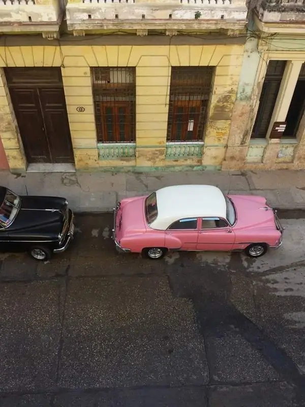 A pink classic car seen from above.